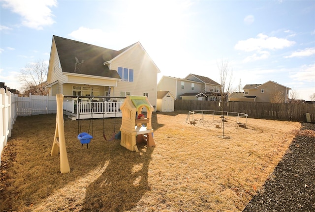 exterior space featuring a playground and a fenced backyard