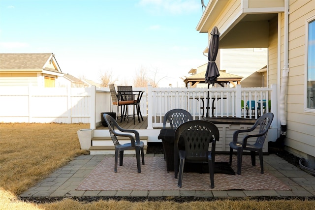 view of patio featuring fence and a wooden deck