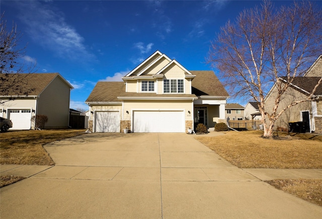 view of front of house with fence and concrete driveway