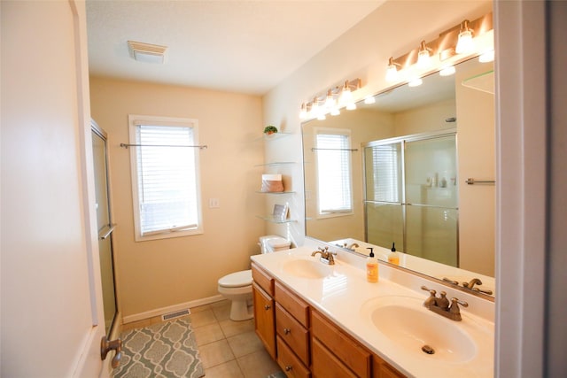 full bathroom with toilet, a stall shower, a sink, and visible vents