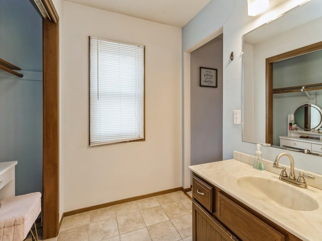 full bathroom featuring vanity and baseboards