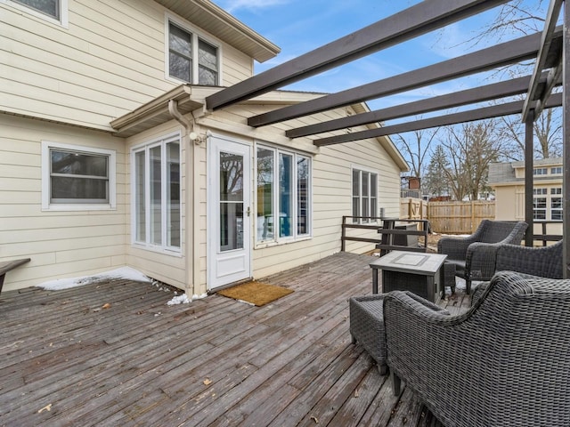 wooden terrace featuring an outdoor living space with a fire pit and fence