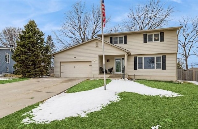 view of front of property with a garage, concrete driveway, a front yard, and fence