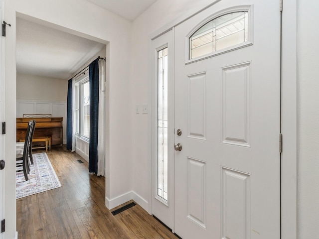 entryway featuring visible vents, baseboards, and dark wood-style flooring