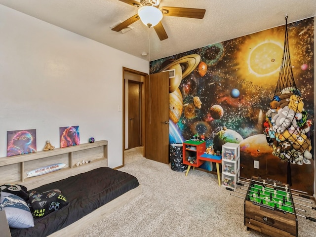 bedroom with carpet flooring, a ceiling fan, and a textured ceiling