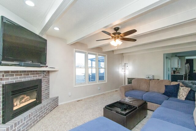 carpeted living room with beamed ceiling, recessed lighting, a brick fireplace, and baseboards