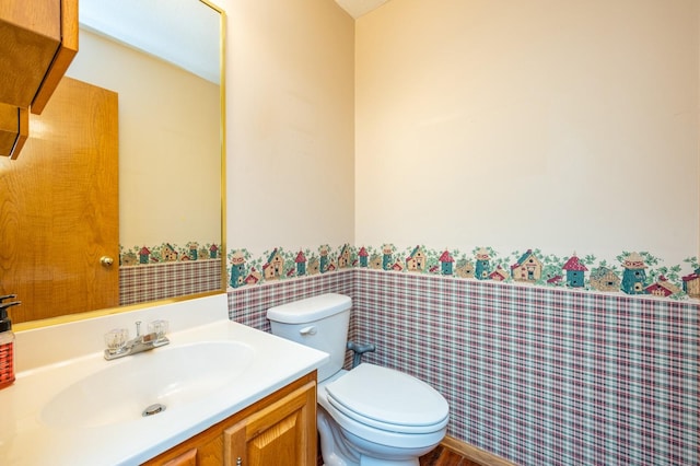 bathroom featuring toilet and vanity