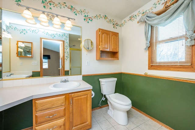 bathroom with toilet, tile patterned flooring, a shower, and vanity