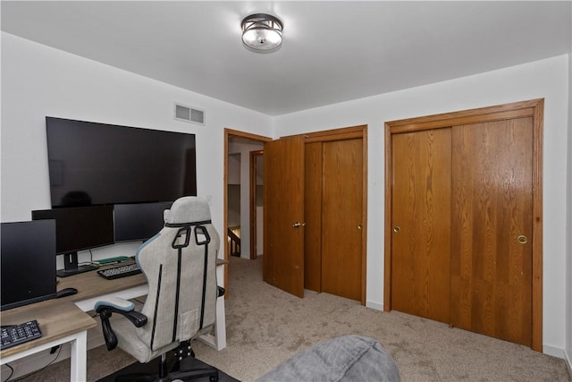 carpeted office space featuring visible vents