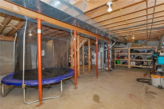 unfinished basement with heating unit, washer / dryer, and gas water heater