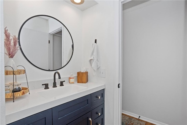 bathroom with baseboards and vanity