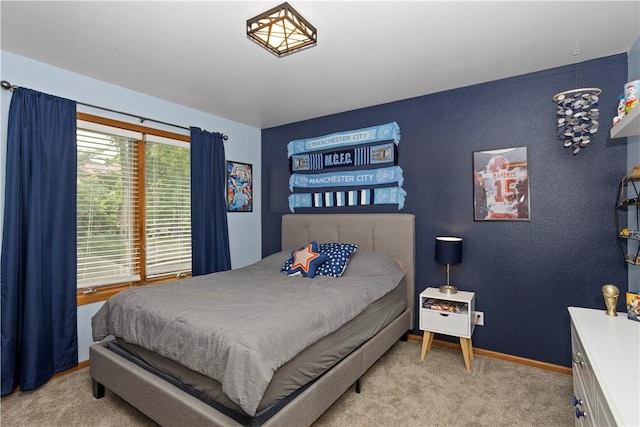 bedroom featuring carpet and baseboards