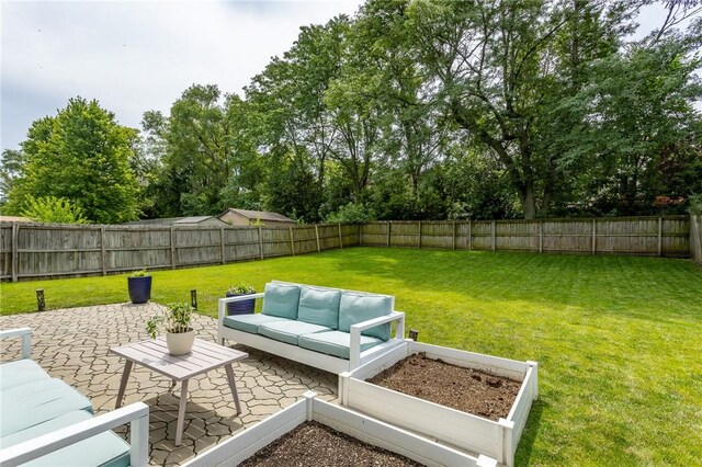 view of yard featuring outdoor lounge area, a patio area, and a fenced backyard