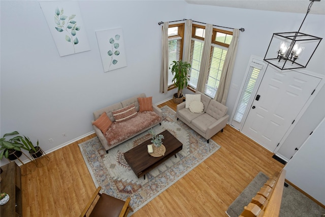 7014 Northview Dr, Urbandale, IA 50322 - living room featuring light wood finished floors and a chandelier