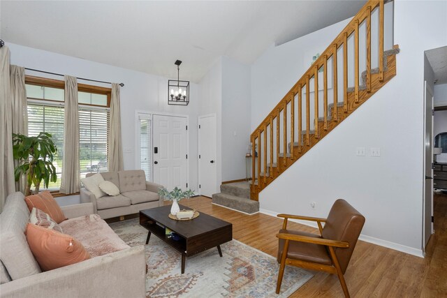 7014 Northview Dr, Urbandale, IA 50322 - living area with stairway, a chandelier, and wood finished floors