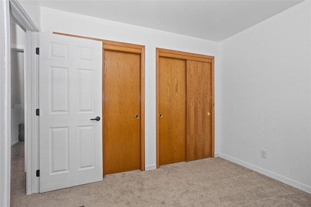 7014 Northview Dr, Urbandale, IA 50322 - unfurnished bedroom featuring two closets and carpet