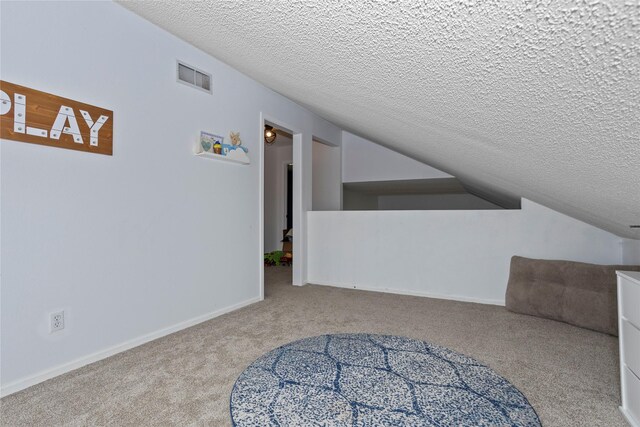 7014 Northview Dr, Urbandale, IA 50322 - bonus room featuring a textured ceiling, carpet, and vaulted ceiling