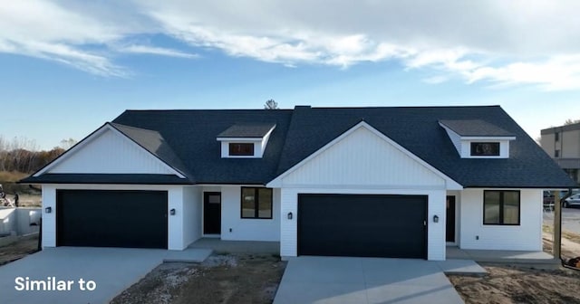 modern farmhouse with roof with shingles, driveway, and an attached garage