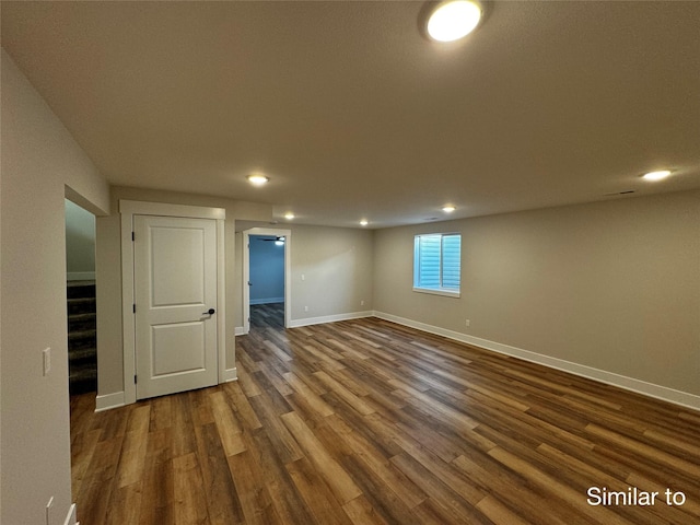 basement featuring stairs, dark wood-style flooring, recessed lighting, and baseboards