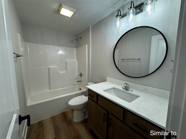 bathroom with vanity, bathtub / shower combination, wood finished floors, and toilet