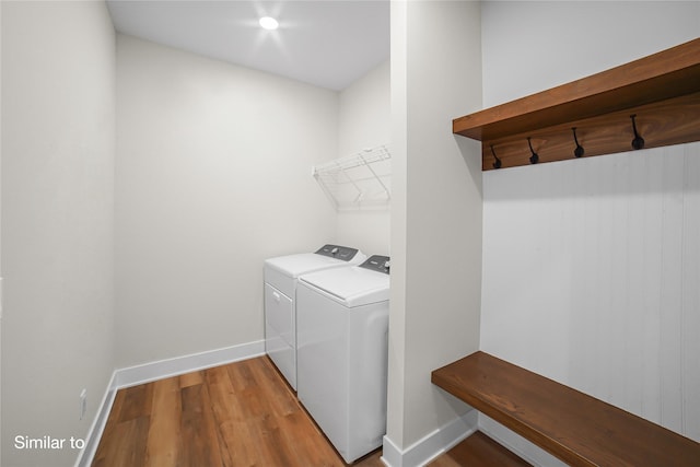 712 Academy Cir, Nevada, IA 50201 - laundry room with washer and clothes dryer, wood finished floors, and baseboards