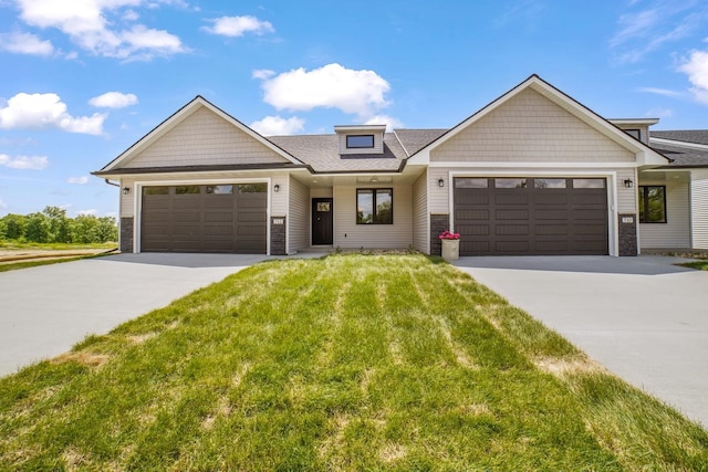 712 Academy Cir, Nevada, IA 50201 - view of front of house featuring driveway, an attached garage, a front lawn, and roof with shingles