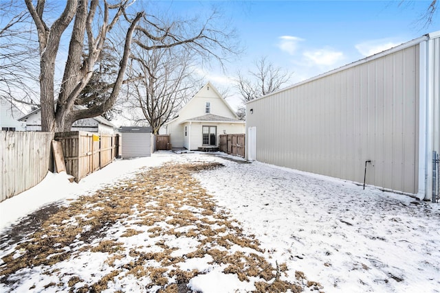 exterior space with an outbuilding, a storage unit, and a fenced backyard