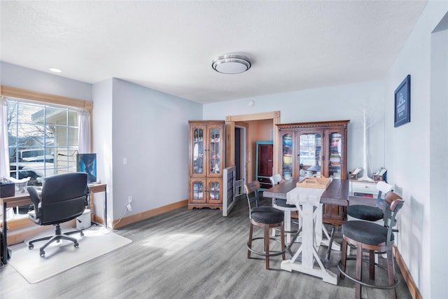 dining room with wood finished floors and baseboards