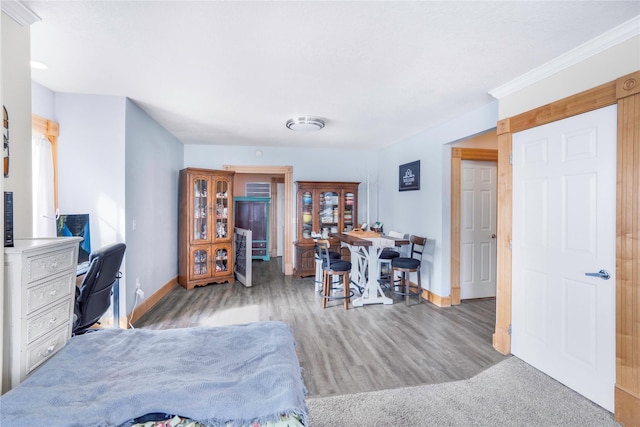 bedroom featuring baseboards and wood finished floors