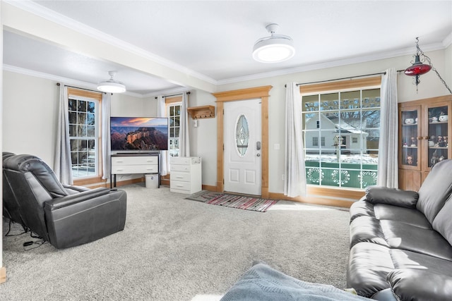 living room with carpet flooring, plenty of natural light, and ornamental molding