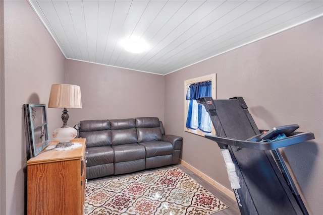 living area with light wood-style flooring, wood ceiling, and baseboards