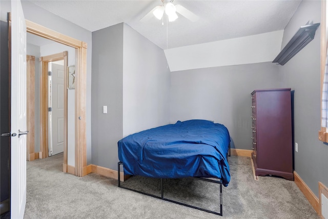 carpeted bedroom with visible vents, baseboards, a ceiling fan, and vaulted ceiling