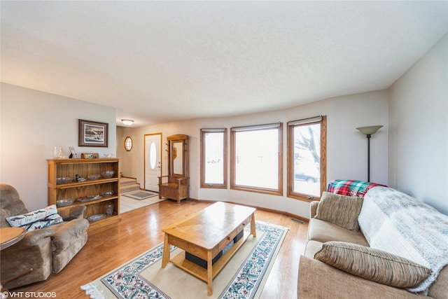 living room with stairway and light wood-style flooring