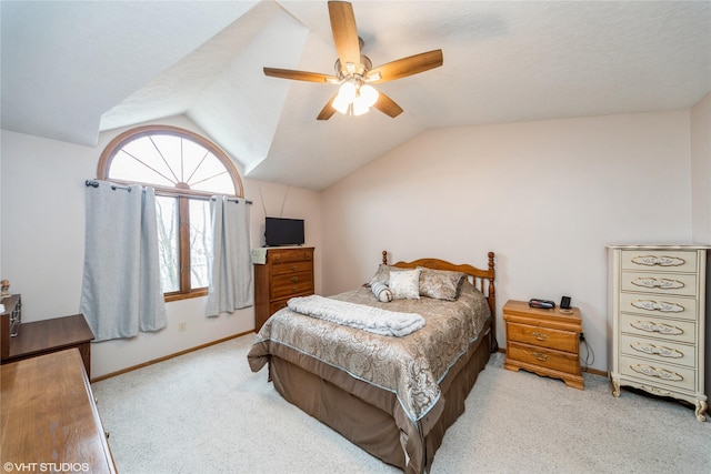 carpeted bedroom featuring lofted ceiling, ceiling fan, a textured ceiling, and baseboards