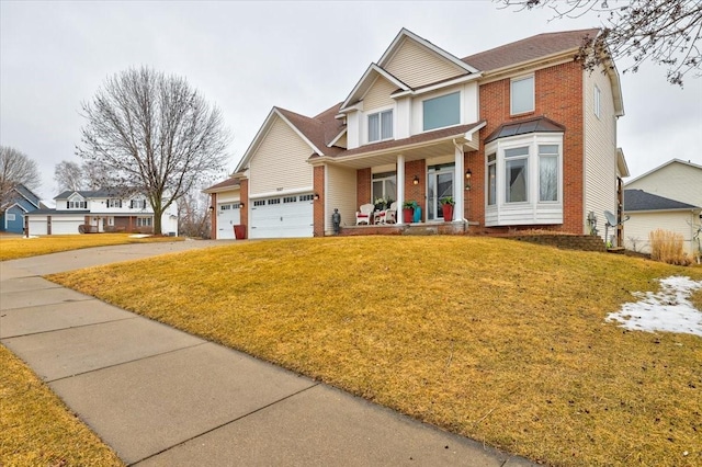 view of front of house featuring a front yard, covered porch, brick siding, and driveway