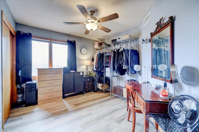 7087 Hillcrest Ct, Johnston, IA 50131 - walk in closet with wood finished floors and a ceiling fan