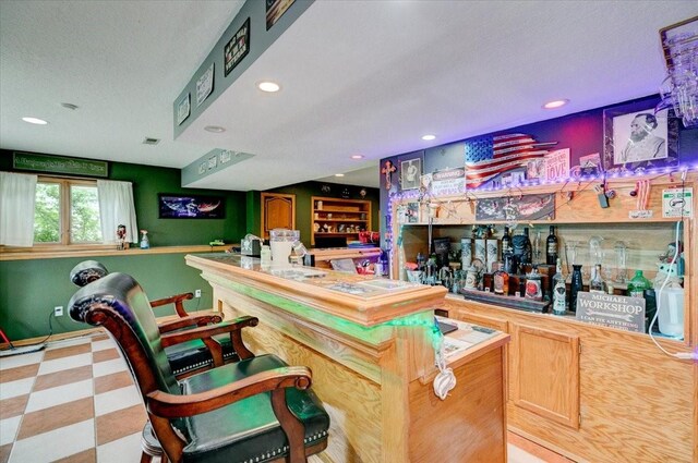 7087 Hillcrest Ct, Johnston, IA 50131 - indoor dry bar featuring tile patterned floors, recessed lighting, a textured ceiling, and baseboards