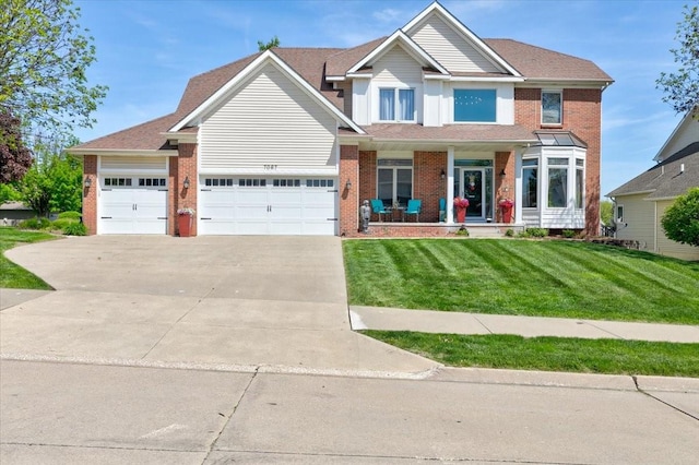 7087 Hillcrest Ct, Johnston, IA 50131 - view of front of property featuring concrete driveway, covered porch, a garage, and brick siding