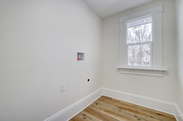 washroom with hookup for a washing machine, laundry area, wood finished floors, baseboards, and electric dryer hookup