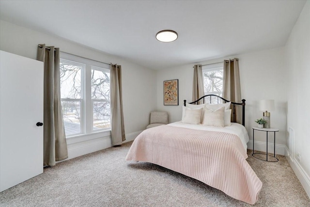 carpeted bedroom featuring baseboards