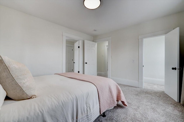 carpeted bedroom with baseboards