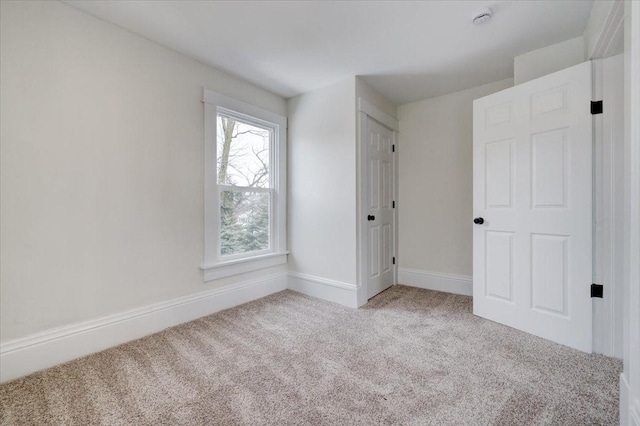 interior space with carpet and baseboards