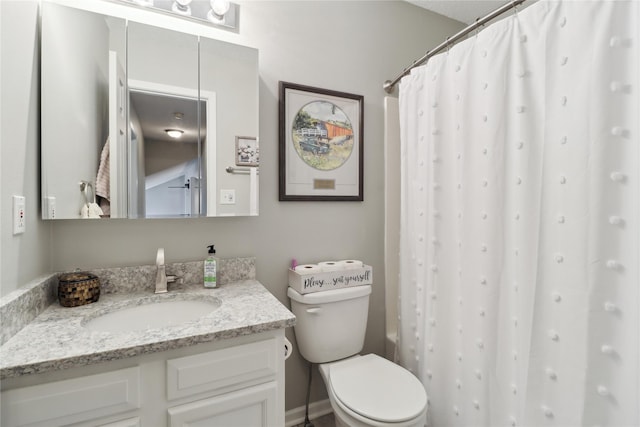 bathroom featuring toilet, a shower with shower curtain, and vanity