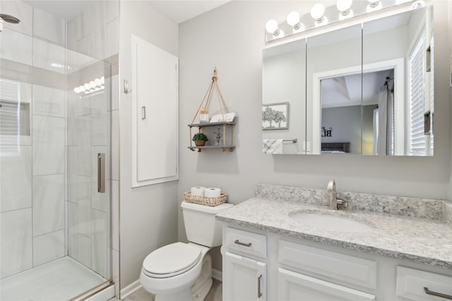 full bath featuring a stall shower, baseboards, vanity, and toilet