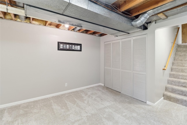 finished below grade area featuring carpet, stairs, and baseboards