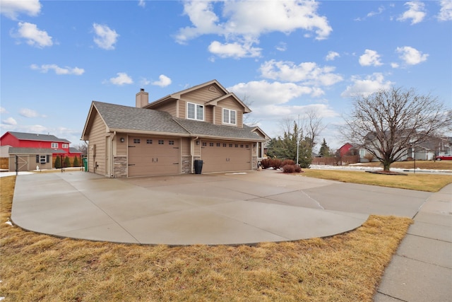 view of side of property featuring stone siding, a shingled roof, a chimney, and driveway