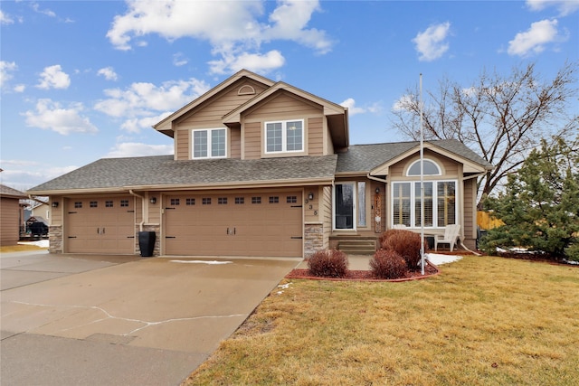 view of front facade with stone siding, a front lawn, roof with shingles, and concrete driveway