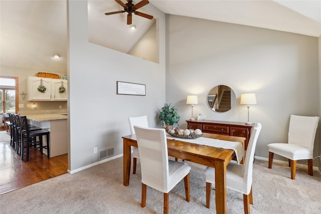 dining room featuring light carpet, baseboards, and visible vents