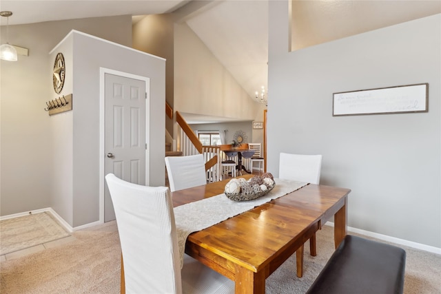 dining space featuring light carpet, baseboards, stairway, a notable chandelier, and beam ceiling