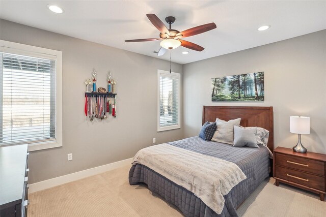 bedroom with a ceiling fan, recessed lighting, light colored carpet, and baseboards